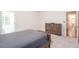 Bedroom with a bed frame, dresser and doorway to the hallway at 403 Hidden Hills Ct, Canton, GA 30115