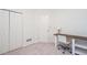 Bedroom with bi-fold closet doors, white door and a desk and a lamp at 403 Hidden Hills Ct, Canton, GA 30115