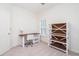 Bright bedroom with a wooden desk and a modern white bookshelf for storage at 403 Hidden Hills Ct, Canton, GA 30115
