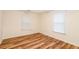 Small bedroom with wood-look floors and two windows with blinds at 403 Hidden Hills Ct, Canton, GA 30115