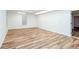 An expansive room offering a blank canvas with clean, white walls and wood plank flooring at 403 Hidden Hills Ct, Canton, GA 30115