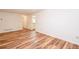 An expansive room offering a blank canvas with clean, white walls and wood plank flooring at 403 Hidden Hills Ct, Canton, GA 30115