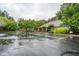 Community clubhouse with ample parking and accessible entrance nestled among mature shade trees at 403 Hidden Hills Ct, Canton, GA 30115