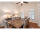 Dining room with hardwood floors, modern ceiling fan, and decoratively-lit display cabinet at 403 Hidden Hills Ct, Canton, GA 30115