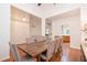 Open dining room featuring hardwood floors and a rustic wood table with seating for eight at 403 Hidden Hills Ct, Canton, GA 30115