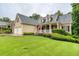 Charming home with a manicured lawn, complemented by a welcoming front porch and an American flag waving proudly at 403 Hidden Hills Ct, Canton, GA 30115