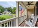 Relaxing front porch furnished with rocking chairs and a barrel table, offering a cozy outdoor space at 403 Hidden Hills Ct, Canton, GA 30115