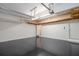 Spacious garage featuring high ceilings, storage shelves, and pristine epoxy floors at 403 Hidden Hills Ct, Canton, GA 30115