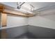 Spacious garage featuring high ceilings, storage shelves, and pristine epoxy floors at 403 Hidden Hills Ct, Canton, GA 30115