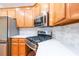 Modern kitchen featuring stainless appliances, gas range, and stylish backsplash at 403 Hidden Hills Ct, Canton, GA 30115
