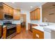 Gourmet kitchen boasts stainless steel appliances, wood cabinets, and sleek countertops at 403 Hidden Hills Ct, Canton, GA 30115