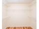 Empty walk-in closet with wire shelving and wood-look floors at 403 Hidden Hills Ct, Canton, GA 30115