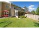 Lush backyard featuring a screened-in porch and outdoor dining area at 100 Trailside Way, Hiram, GA 30141