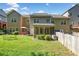 Fenced backyard with lush green lawn and screened in porch at 100 Trailside Way, Hiram, GA 30141