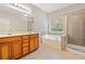 Primary bath boasts double vanity, soaking tub, and glass shower at 100 Trailside Way, Hiram, GA 30141