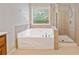 Bright bathroom features a soaking tub and glass-enclosed shower at 100 Trailside Way, Hiram, GA 30141