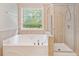 Bathroom featuring a soaking tub and separate walk-in shower at 100 Trailside Way, Hiram, GA 30141