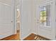 This entryway features beautiful hardwood floors, a stylish half-bath and a bright door at 100 Trailside Way, Hiram, GA 30141
