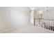 Upstairs hallway features carpet and wood railing on the stairway at 100 Trailside Way, Hiram, GA 30141