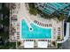 Overhead shot of a pool deck, lounge chairs, tables, and umbrellas by a modern high-rise building at 1080 Peachtree Ne St # 1402, Atlanta, GA 30309