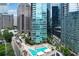 High-rise residential building with an rooftop pool and lounge area, surrounded by city skyline at 1080 Peachtree Ne St # 1402, Atlanta, GA 30309