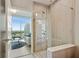 Luxurious bathroom features glass shower and views of the city at 1080 Peachtree Ne St # 1402, Atlanta, GA 30309