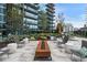 Outdoor patio area with fire pit and seating surrounded by greenery at 1080 Peachtree Ne St # 1402, Atlanta, GA 30309