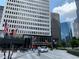 A vibrant street scene showcasing a WeWork and Starbucks, surrounded by modern buildings in a commercial district at 1080 Peachtree Ne St # 1402, Atlanta, GA 30309