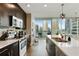 Gourmet kitchen with stainless steel appliances, granite countertops, and stunning city views from the large windows at 1080 Peachtree Ne St # 1402, Atlanta, GA 30309