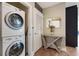 Laundry room features modern washer and dryer units at 1080 Peachtree Ne St # 1402, Atlanta, GA 30309
