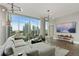 Bright living room featuring expansive windows with city views and stylish contemporary furnishings at 1080 Peachtree Ne St # 1402, Atlanta, GA 30309