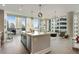 Open-concept living space with a kitchen island, floor-to-ceiling windows, and cityscape views at 1080 Peachtree Ne St # 1402, Atlanta, GA 30309