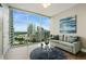 Bright living room with stunning city views, modern furniture, and stylish decor at 1080 Peachtree Ne St # 1402, Atlanta, GA 30309