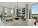 Airy living room with floor-to-ceiling windows showcasing cityscape and sleek, modern furniture at 1080 Peachtree Ne St # 1402, Atlanta, GA 30309