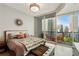Inviting bedroom featuring a luxurious bed, plush furnishings, and access to a private balcony with city views at 1080 Peachtree Ne St # 1402, Atlanta, GA 30309