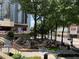 Outdoor seating area surrounded by greenery and trees, providing a relaxing atmosphere near establishments and theater at 1080 Peachtree Ne St # 1402, Atlanta, GA 30309