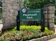 Close-up of the Piedmont Park sign, with colorful flowers and greenery enhancing the park's welcoming appeal at 1080 Peachtree Ne St # 1402, Atlanta, GA 30309