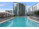 Stunning outdoor pool with lounge chairs surrounded by high-rise buildings on a sunny day at 1080 Peachtree Ne St # 1402, Atlanta, GA 30309
