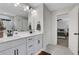 Bathroom featuring a double sink vanity with modern fixtures, a framed mirror, and marble floors at 16 Dovecrest Way, Acworth, GA 30101