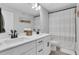 Bathroom with double sinks, white cabinets, and black hardware at 16 Dovecrest Way, Acworth, GA 30101
