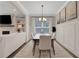 Elegant dining room features modern lighting, wainscoting, and artwork, adjacent to a cozy living area with fireplace at 16 Dovecrest Way, Acworth, GA 30101