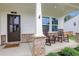 Inviting front porch with stone accents, rocking chairs, and a view of the manicured lawn, creating a warm welcome at 16 Dovecrest Way, Acworth, GA 30101