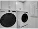Laundry room with front load washer and dryer and white cabinets at 16 Dovecrest Way, Acworth, GA 30101