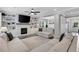 Open-concept living room boasts a fireplace, built-in shelving, ceiling fan, and seamless access to the dining area at 16 Dovecrest Way, Acworth, GA 30101