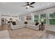 Spacious living room flows into the kitchen with an oversized sofa and windows offering view of the outdoors at 16 Dovecrest Way, Acworth, GA 30101