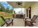 Covered patio with ceiling fan, grill, and chairs at 16 Dovecrest Way, Acworth, GA 30101