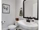Elegant powder room with modern fixtures, a stylish mirror, and a sleek vanity for guests' convenience at 16 Dovecrest Way, Acworth, GA 30101
