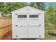 Exterior shot of a storage shed with double doors and windows at 16 Dovecrest Way, Acworth, GA 30101