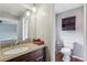Bathroom with granite vanity, dark wood cabinets, and coordinating wall storage at 2201 Colonial Oak Way, Stone Mountain, GA 30087