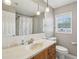 Bright bathroom featuring large mirror, white tiling, and modern lighting at 2201 Colonial Oak Way, Stone Mountain, GA 30087